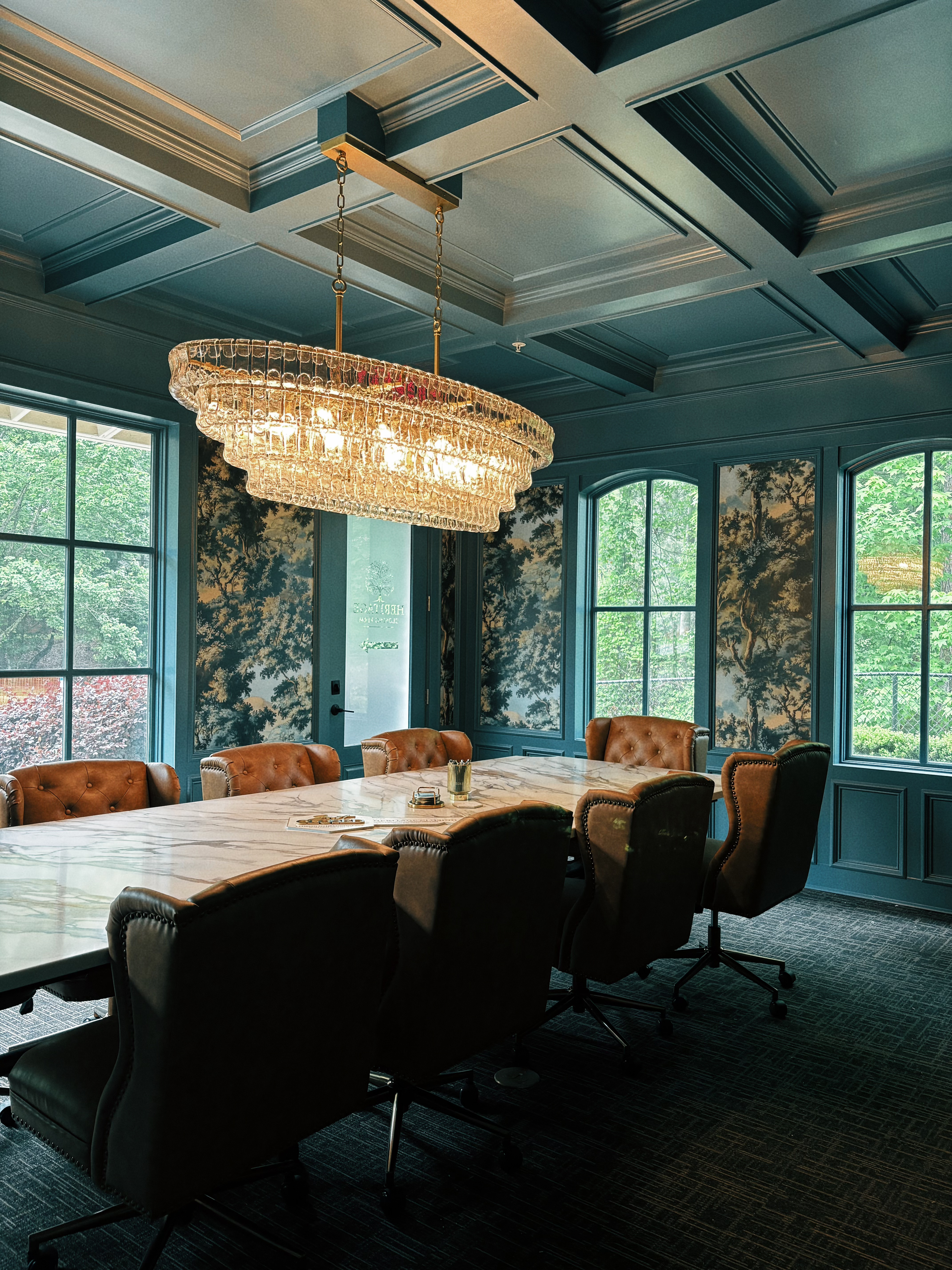 Luxurious closing office with glistening chandelier and european blue walls