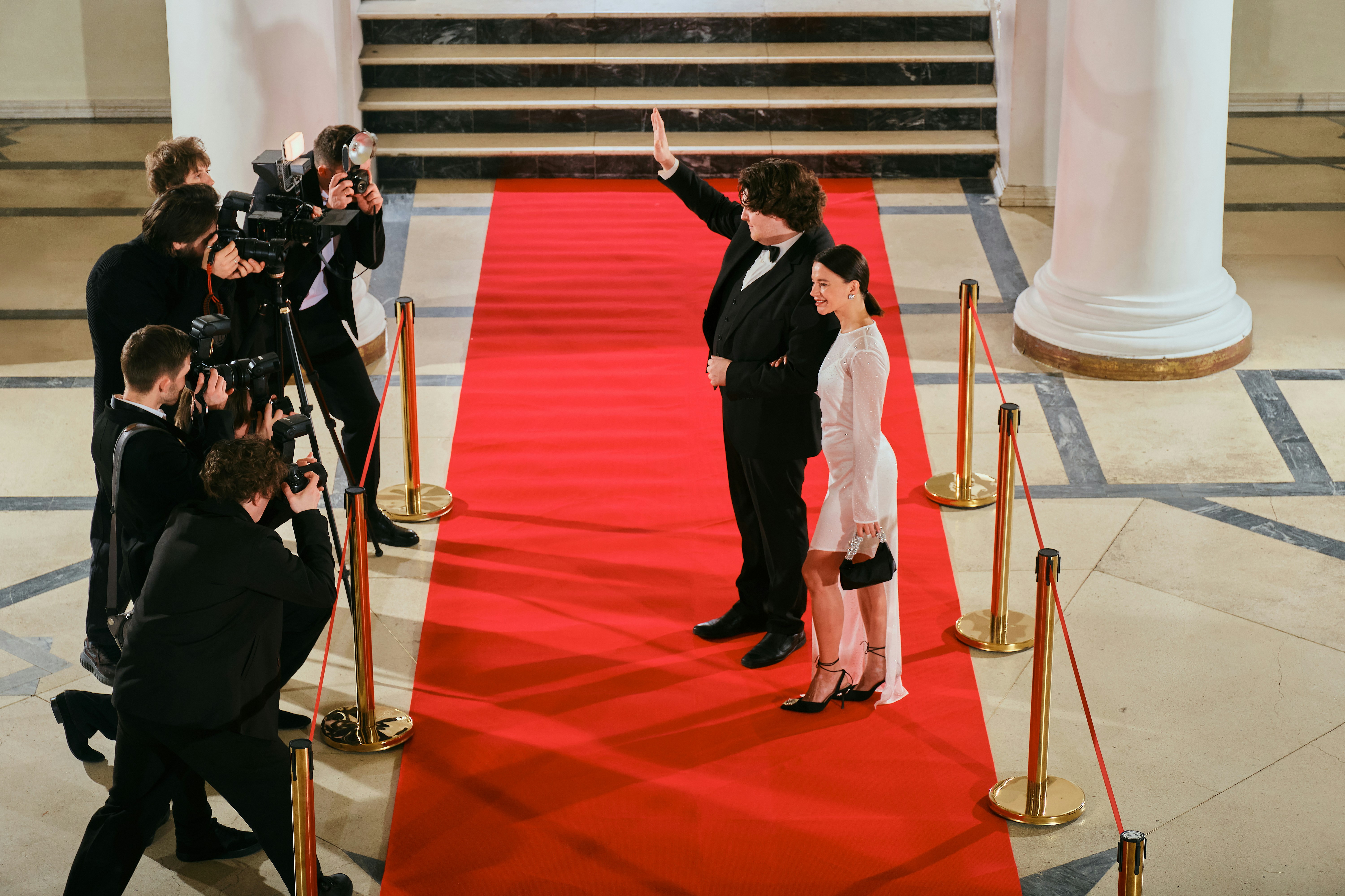 Celebrity couple waving to Papparazzi