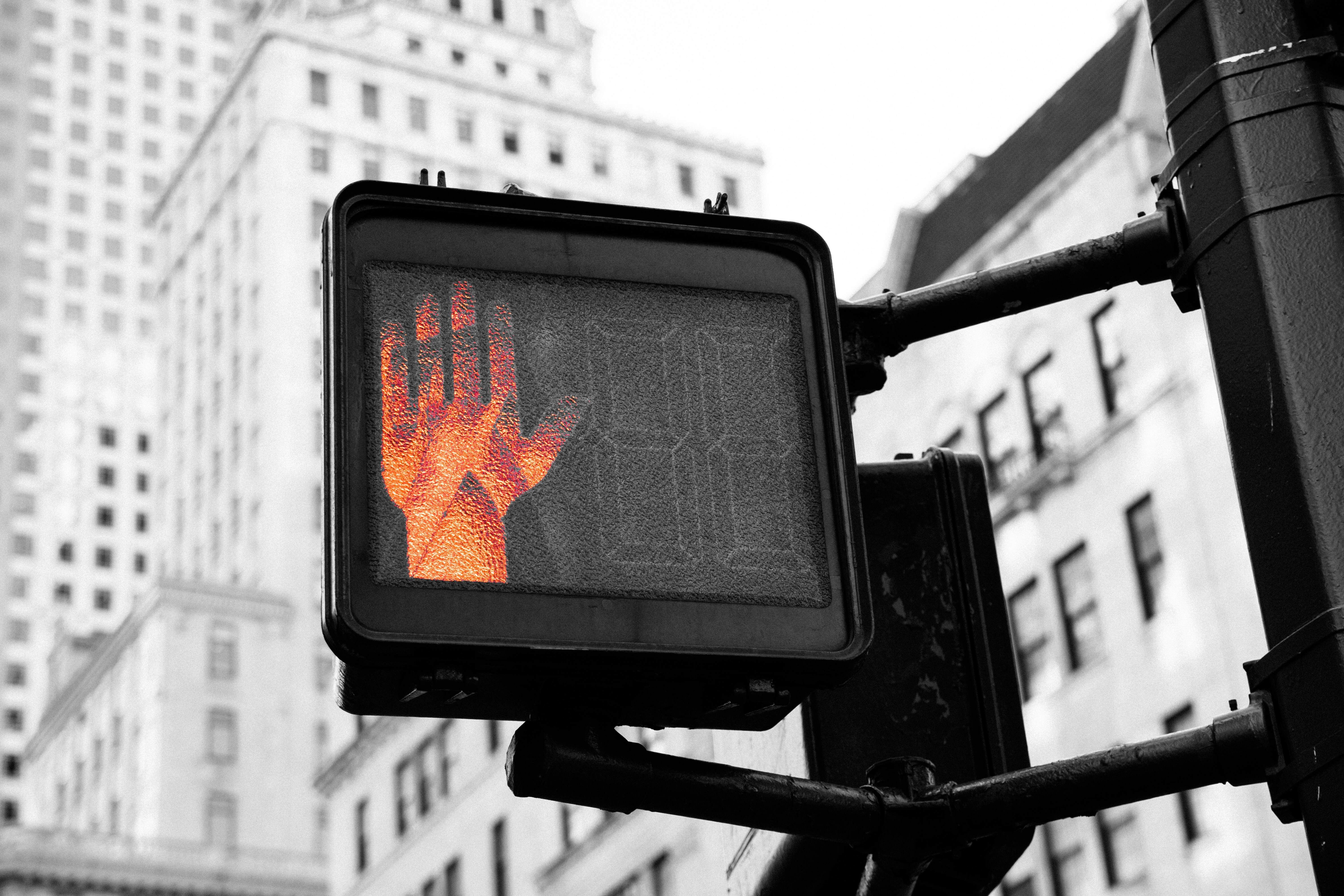 A Red Stop Hand Sign
