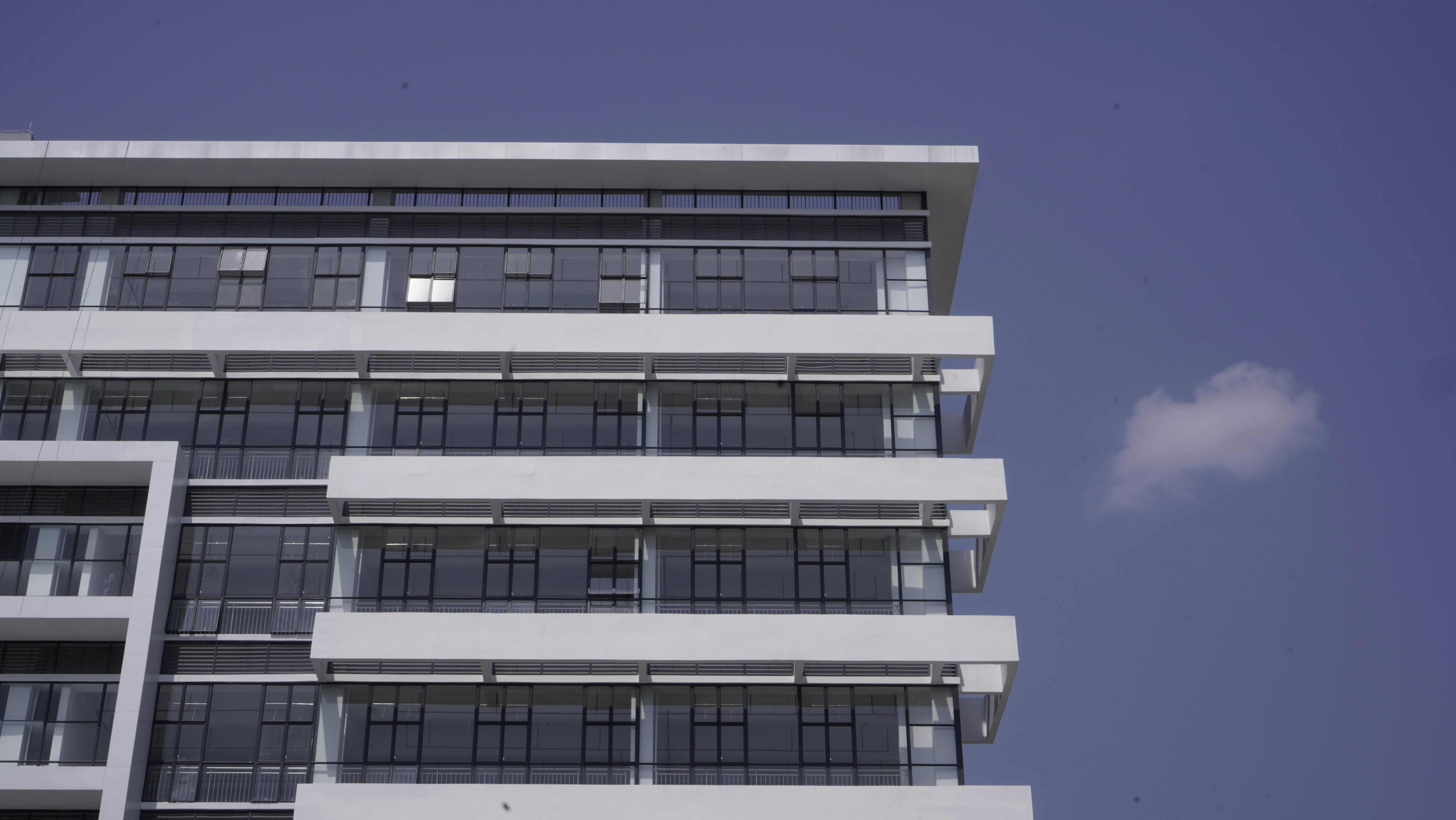 White office building on blue sky background